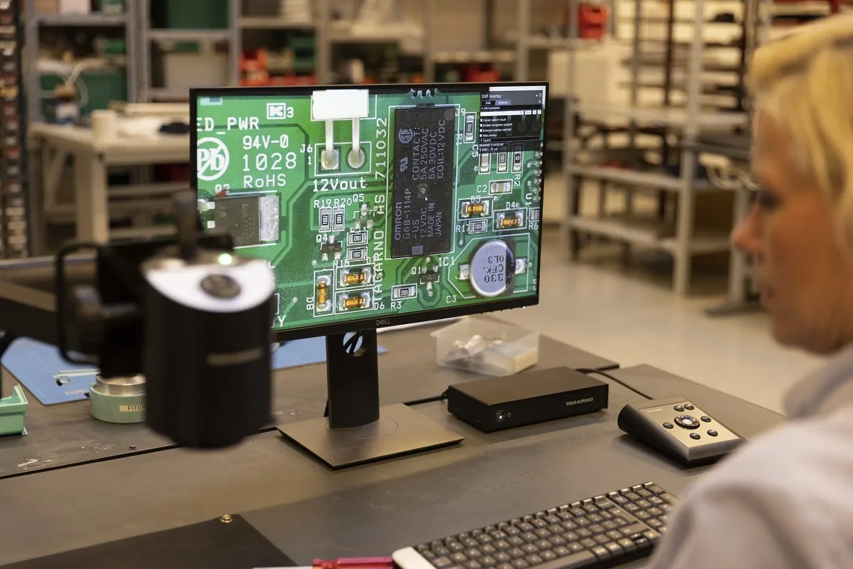 Woman using a multifunctional digital microscope to inspect PCB